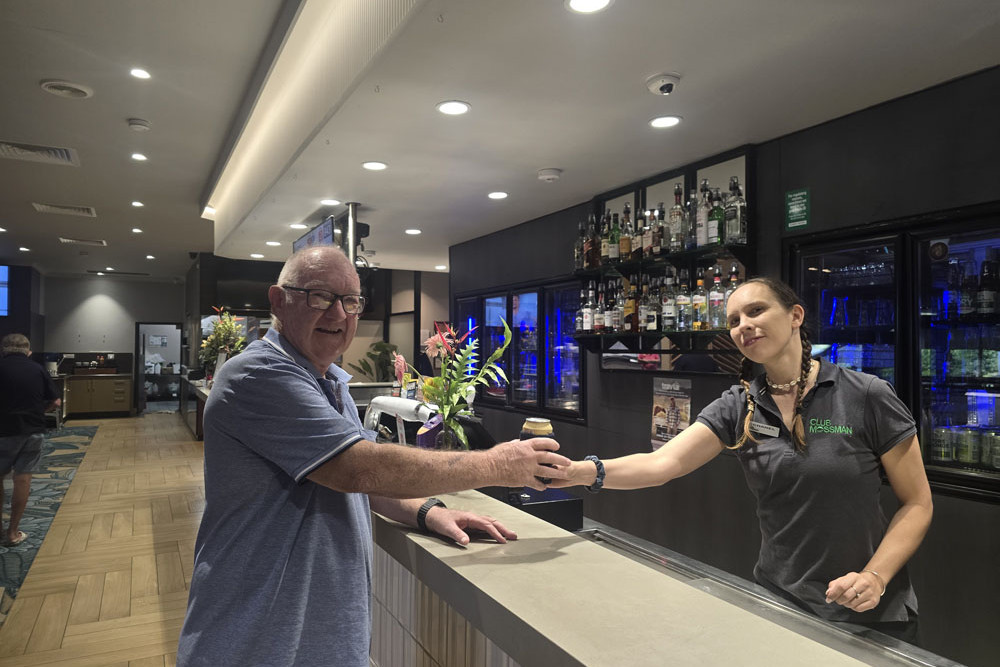 Club Mossman staff member Chanel serves patron Mike (surnames withheld) at the bar. Picture: Supplied
