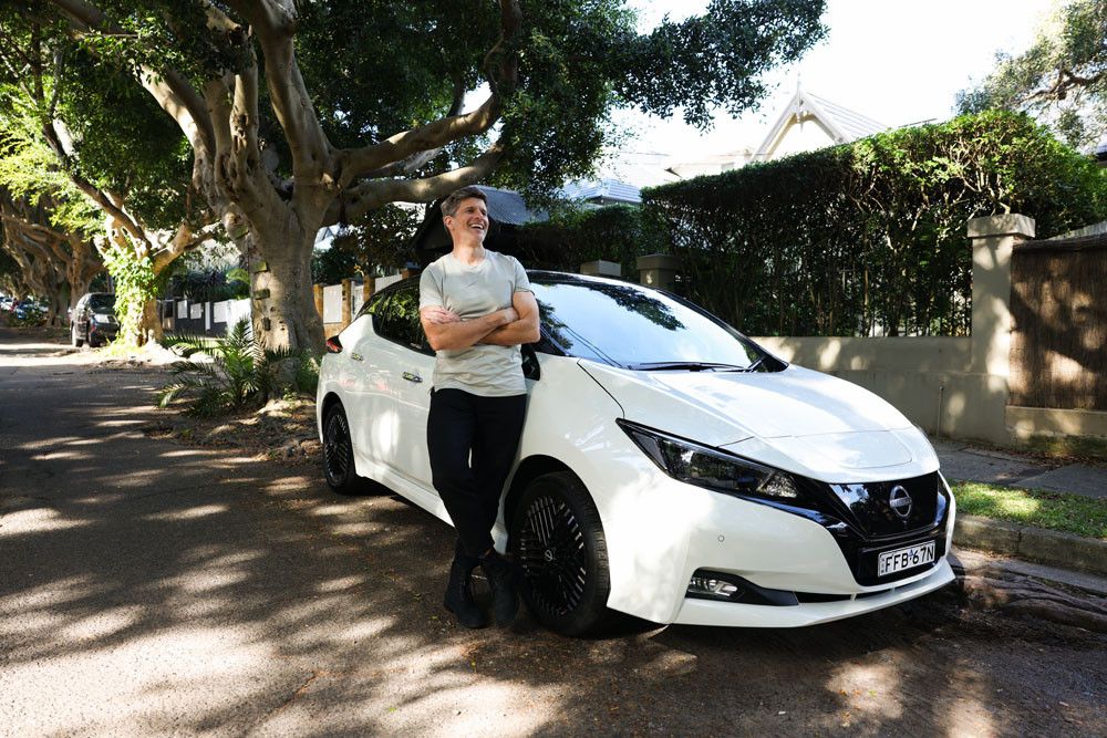 Australian TV show host and journalist Osher Günsberg with his Nissan Leaf EV. Picture: Nissan Australia