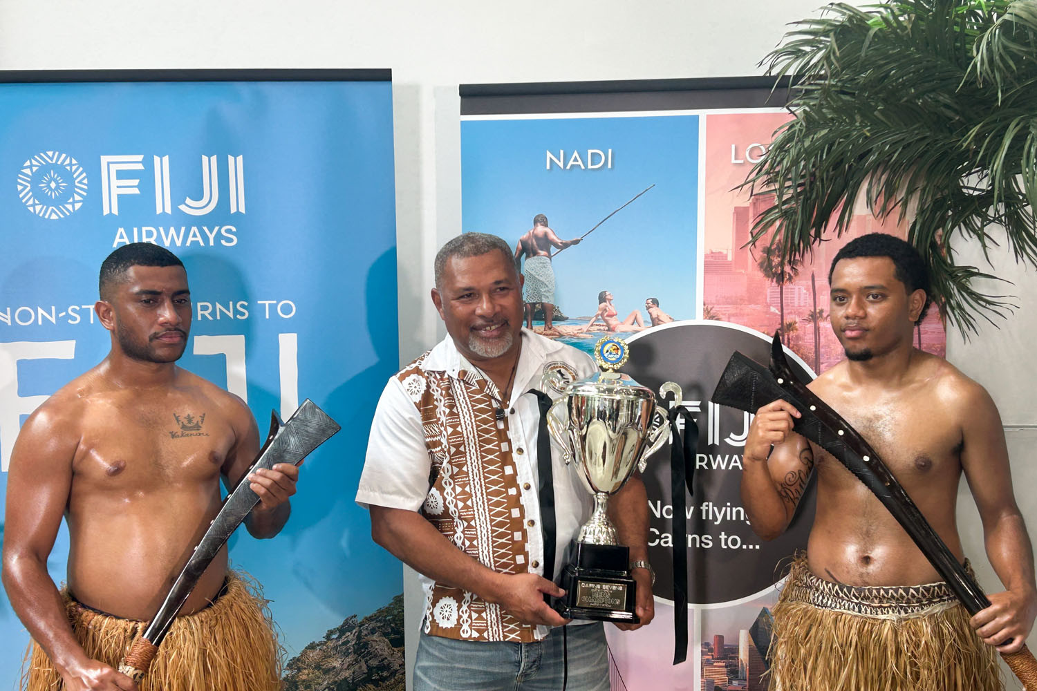 Fijian warriors stand on either side of Fiji Community Association FNQ president Ili Cavans at the launch of the Fiji Airways Cairns 7s Rugby Tournament. Picture: Hugh Bohane