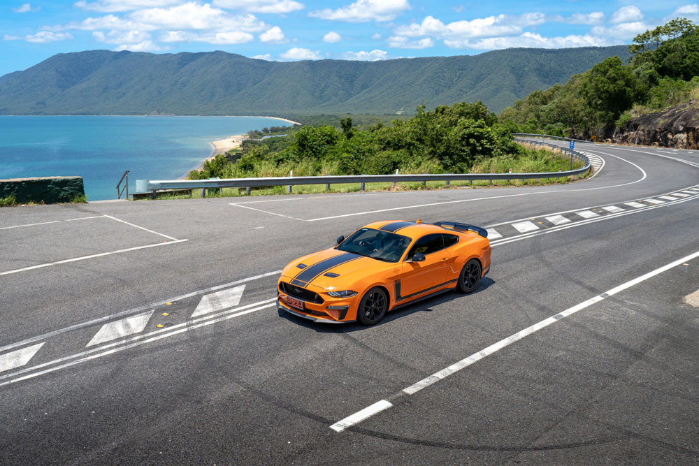 A Luxury Car Hire Ford Mustang passes the famed Rex lookout on the Captain Cook Highway at Wangetti. Picture: Tourism Tropical North Queensland