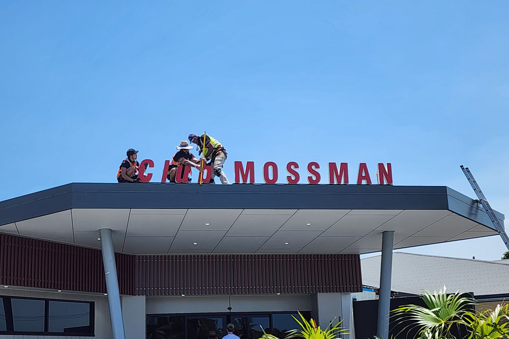 Workers put the finishing touches to the new ‘Club Mossman’ sign above the entrance. Picture: Gary ‘Gazza’ McIlroy