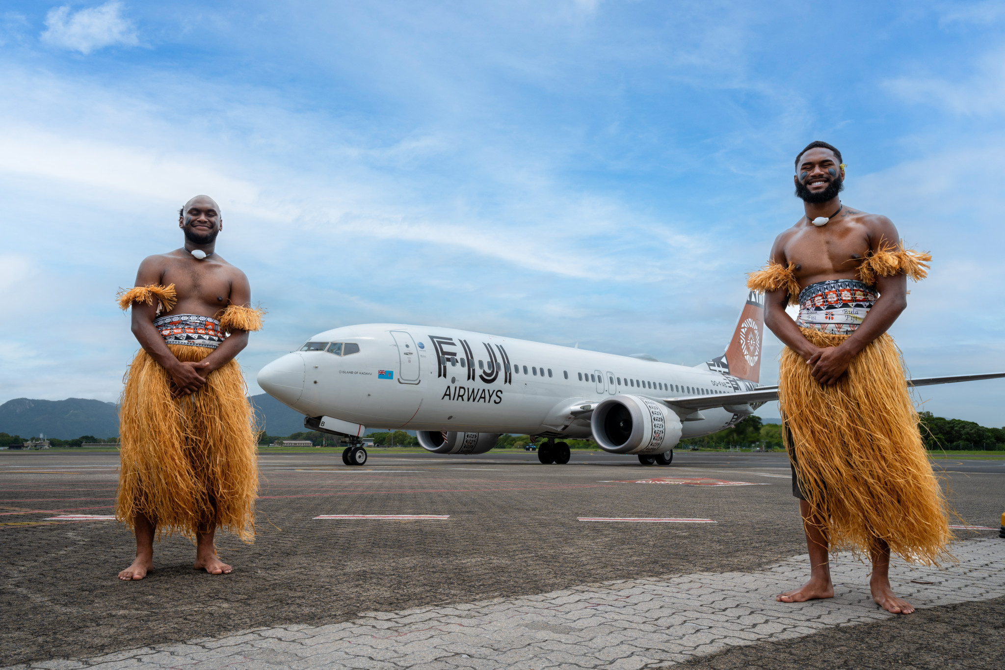 Fijian dancers Ilikena Nalewakana and Brian Nauastralian citizens greet the Fiji Airways Boeing 737 MAX 8. Picture: Cairns Airport