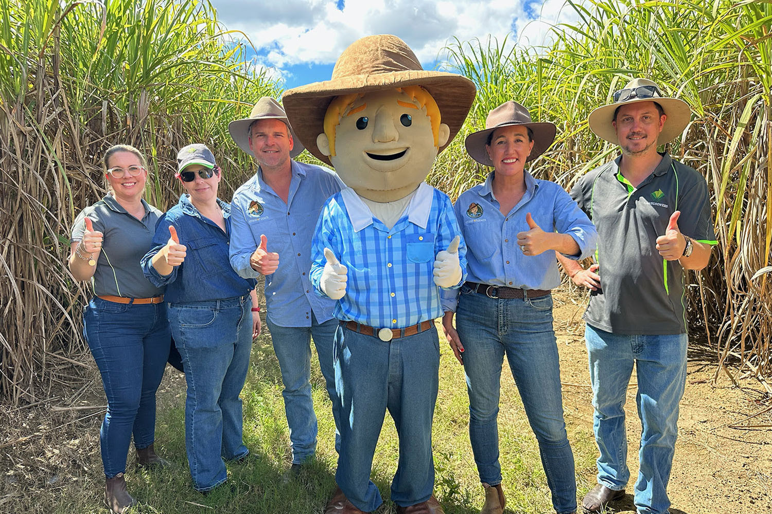 About to board the sugar train are (from left) Shikira Kalatzis of Canegrowers, cane farmer Celiamaree Zarins, the George the Farmer team of Shaun, George and Simone and Joel Teirney, also of Canefarmers. Picture: Supplied