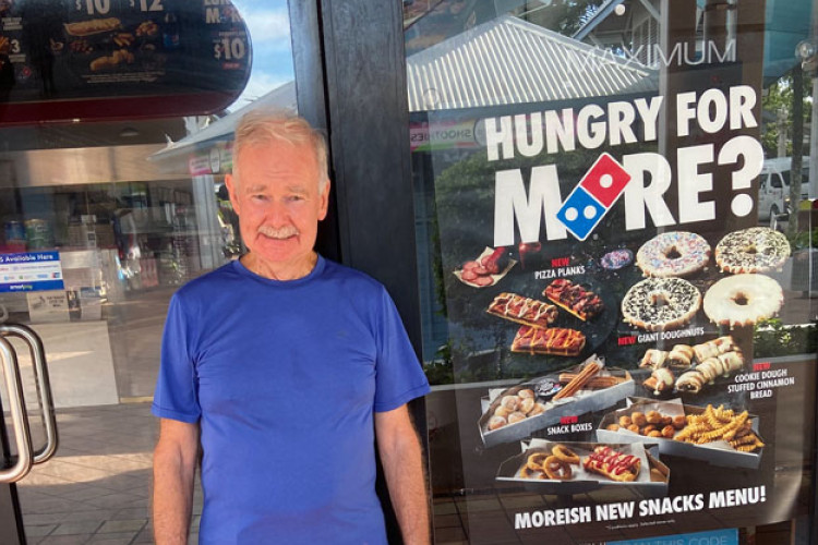 Michael Whalen stands outside the closed Domino’s Pizza outlet in Macrossan Street. Picture: Jake Black